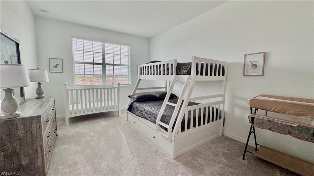 Bunk room with crib and window light